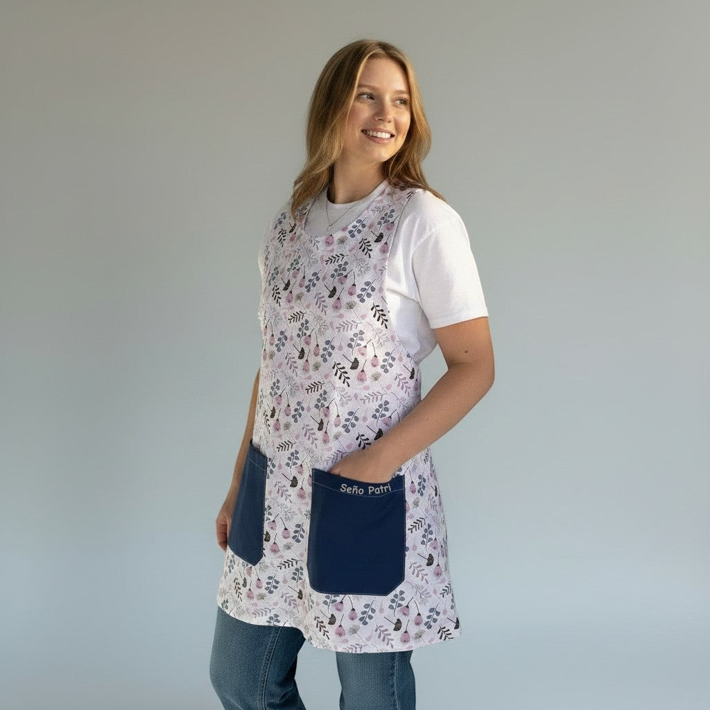 SuYa Shop floral print teacher apron with navy blue pockets worn by a smiling woman