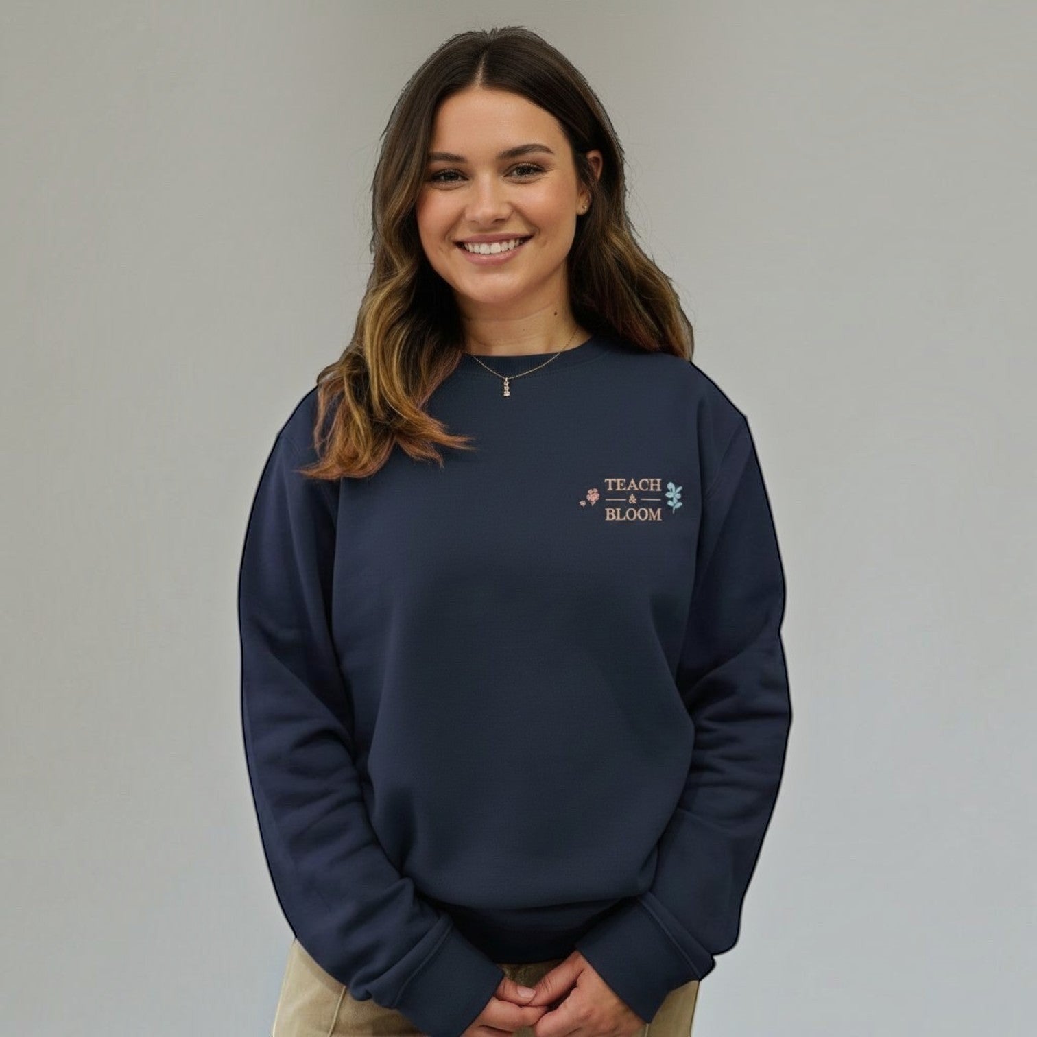 SuYa Shop navy blue sweatshirt with Teach and Bloom floral embroidery worn by a smiling woman
