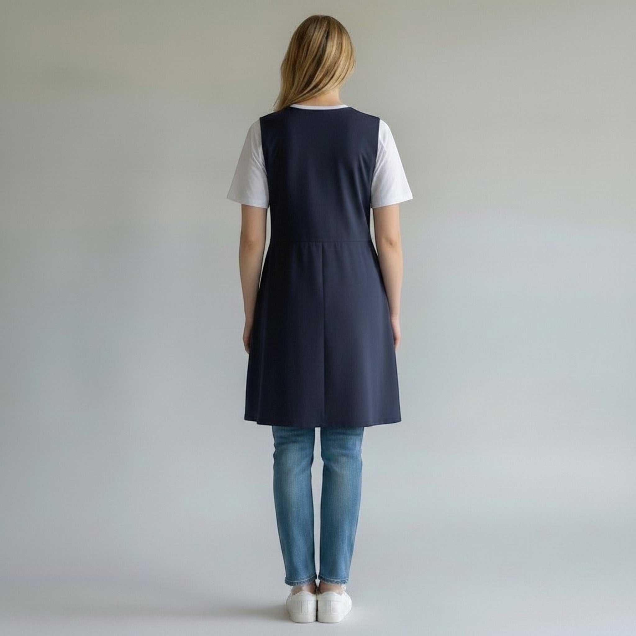 SuYa Shop sleeveless navy blue teacher smock with wrinkle-resistant fabric, back view on a model