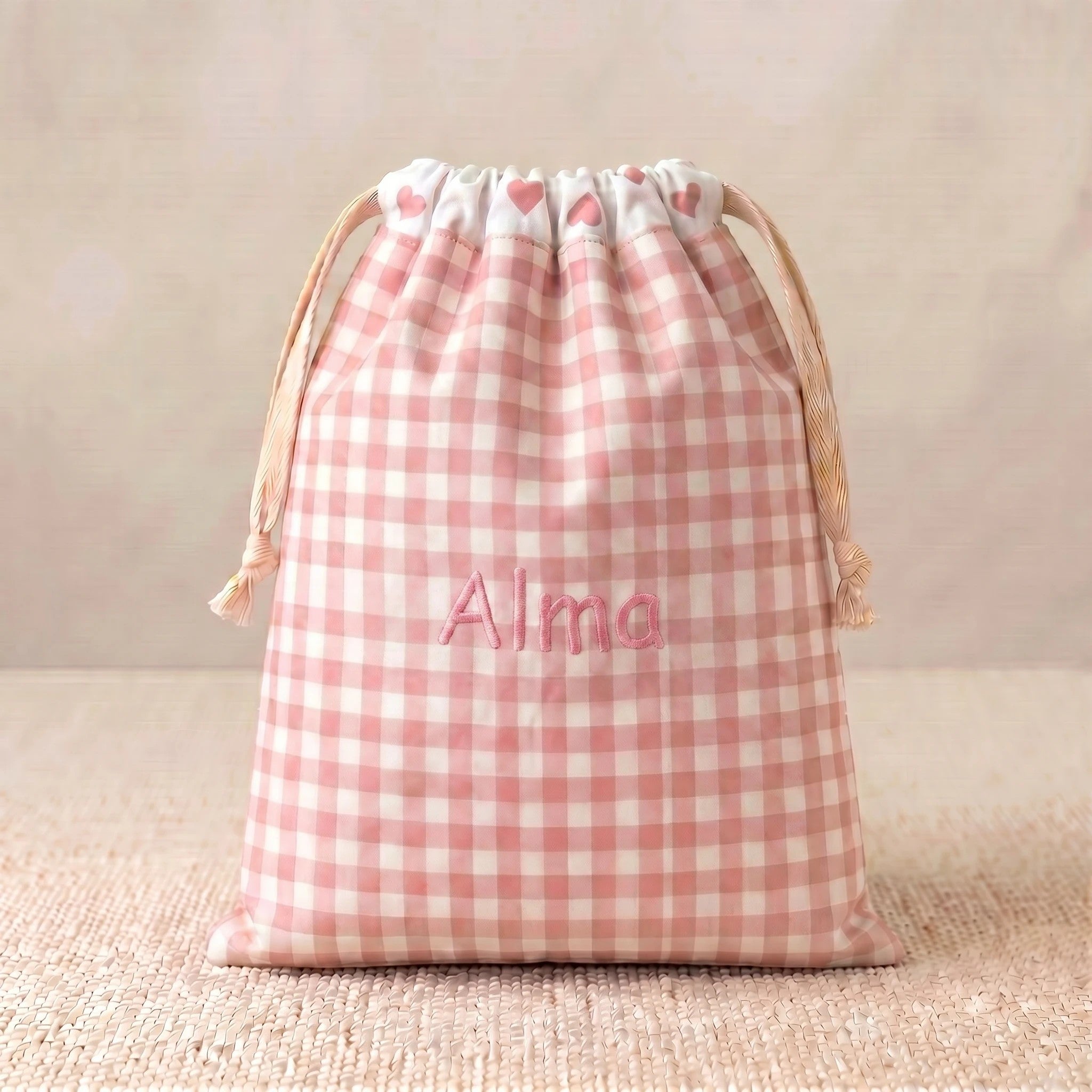 SuYa Shop personalized pink gingham snack bag with heart pattern and embroidered name Alma on a textured surface