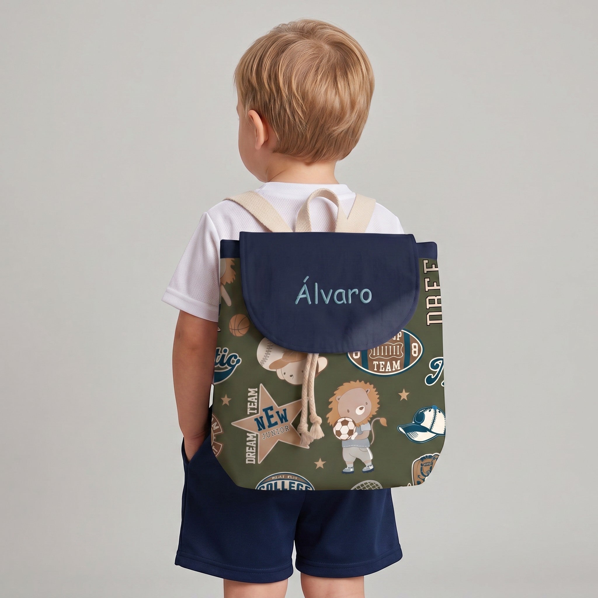 SuYa Shop personalized kids backpack with green sports pattern and name Alvaro, worn by a child on a grey background.