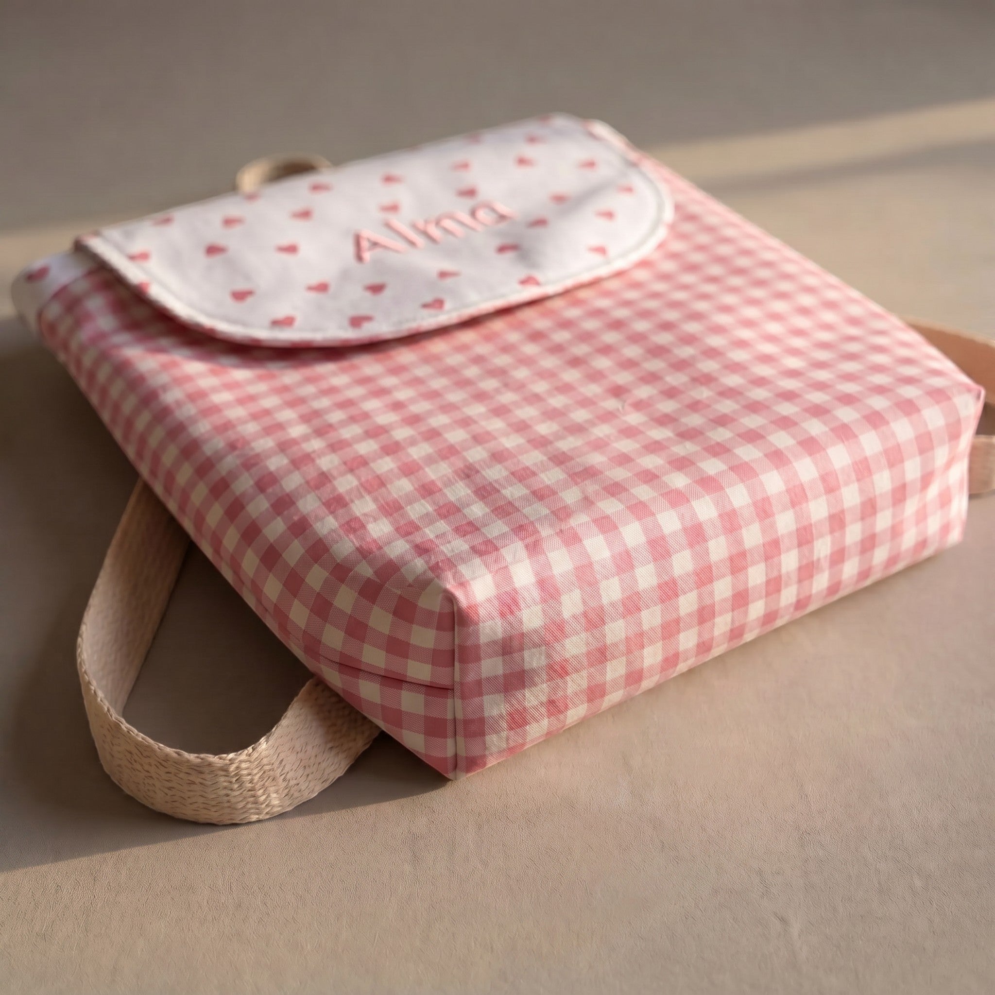 SuYa Shop personalized pink gingham children's backpack with heart pattern and name embroidery on the flap.