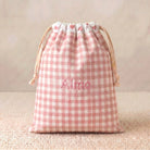 SuYa Shop personalized pink gingham snack bag with heart pattern and embroidered name Alma on a textured surface