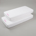Two white SuYa Shop cotton crib sheets for 120x60cm mattresses, each personalized with the name Alma in pink text.