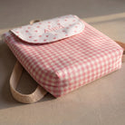 SuYa Shop personalized pink gingham children's backpack with heart pattern and name embroidery on the flap.