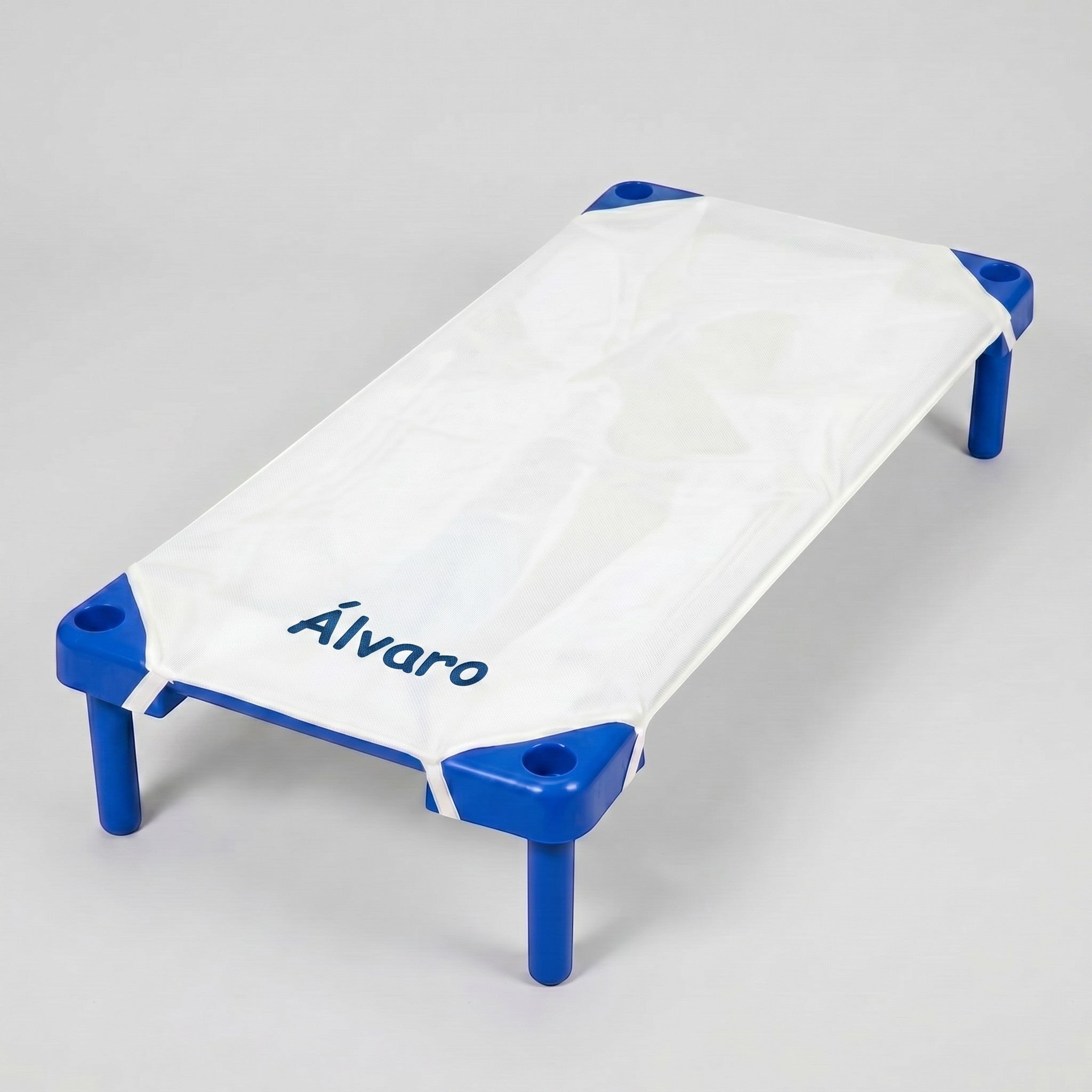 SuYa Shop white cotton fitted school nap sheet with elastic corners and custom embroidered name on a blue cot